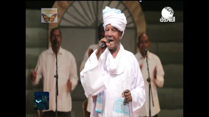 شاهد بالفيديو.. الفنان السوداني الكبير “قيقم” يحكي قصة الأغنية الشهيرة (من الأسكلا وحلا) خلال جلسة خاصة ويكشف عن الفتاة اليهودية الحسناء “إيميلن” التي بسببها كتبت الأغنية